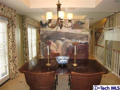 Undisclosed Address Burbank, CA 91501 - Photo 9 of 21 a table with a vase and flowers