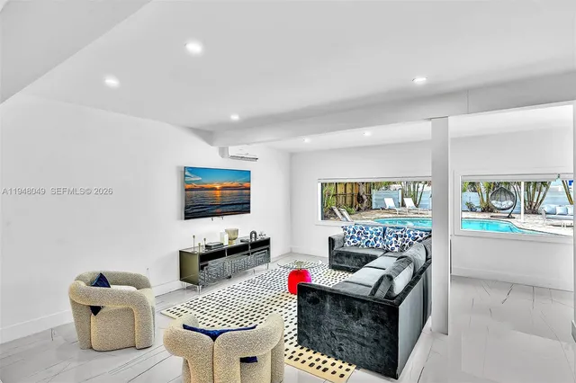 a living room with granite countertop furniture and a wooden floor