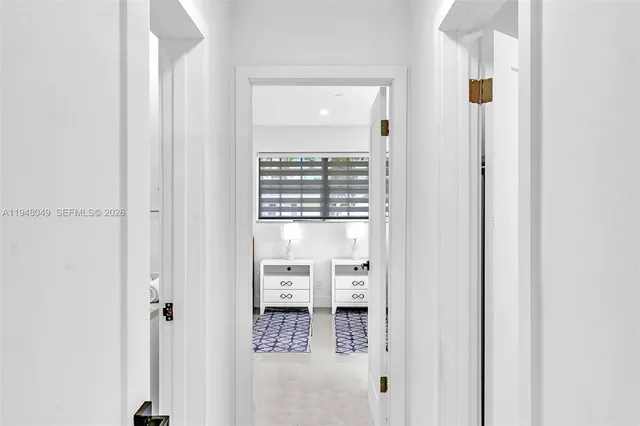 a bathroom with a granite countertop sink a toilet a mirror and shower