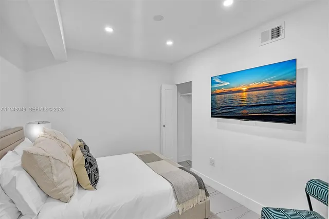 a bedroom with a bed and a couch