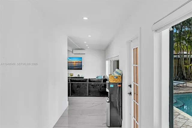 an aerial view of residential houses with outdoor space and trees