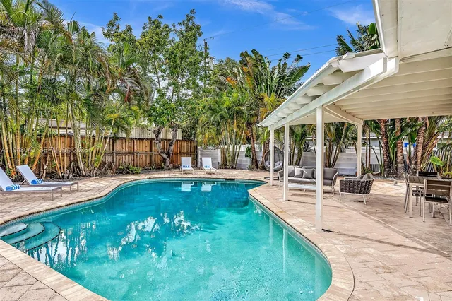 an aerial view of a house with a garden and a yard