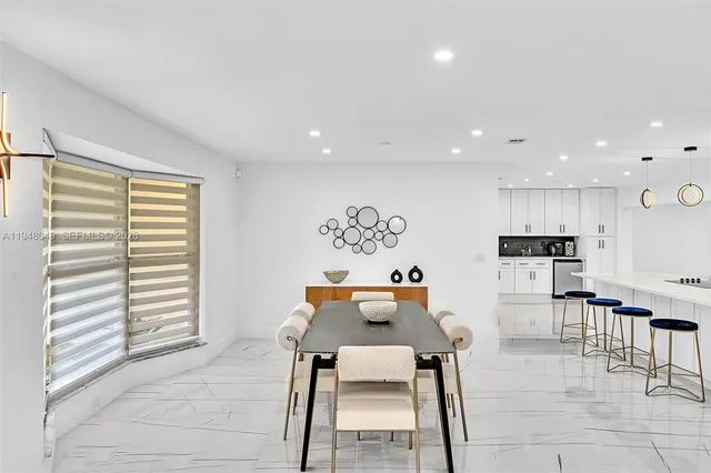 a bedroom with a bed and a table with potted plant