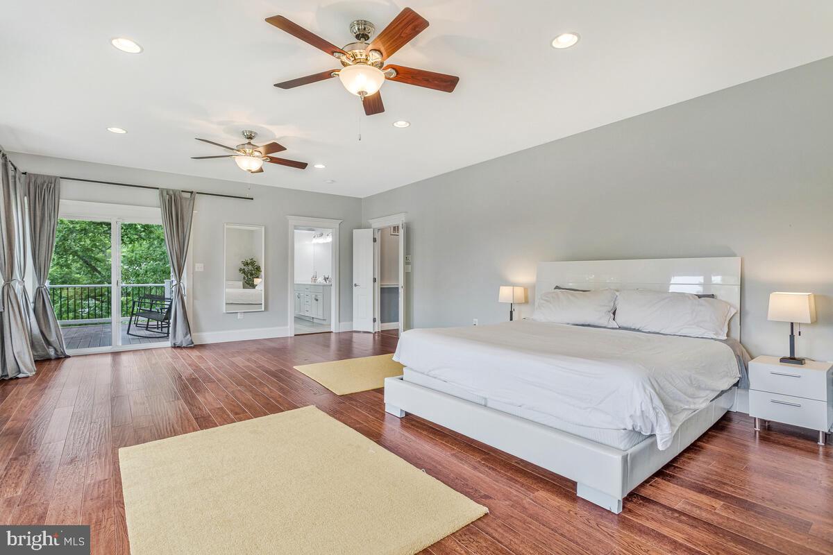 50333 Scotland Beach Road Scotland, MD 20687 - Photo 26 of 95 a bedroom with a large bed chandelier and a large window