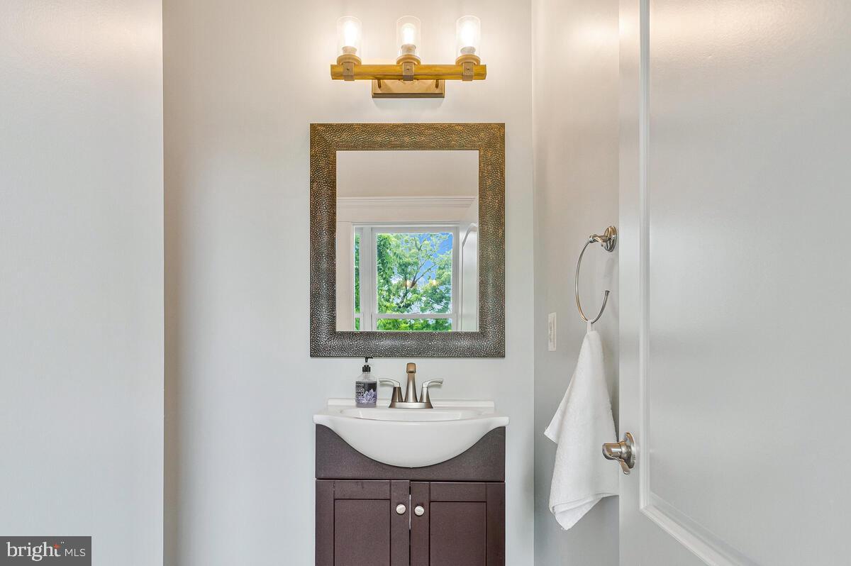 50333 Scotland Beach Road Scotland, MD 20687 - Photo 29 of 95 a bathroom with a sink a mirror and a window