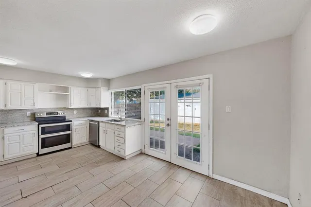 a kitchen with stainless steel appliances granite countertop a refrigerator sink and stove