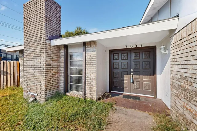a view of an empty room with a fireplace and a window