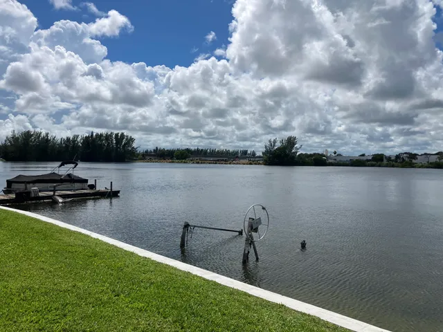 a front view of a house with a garden and yard