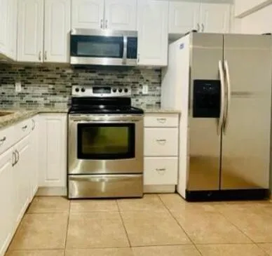 a view of a sink near a refrigerator