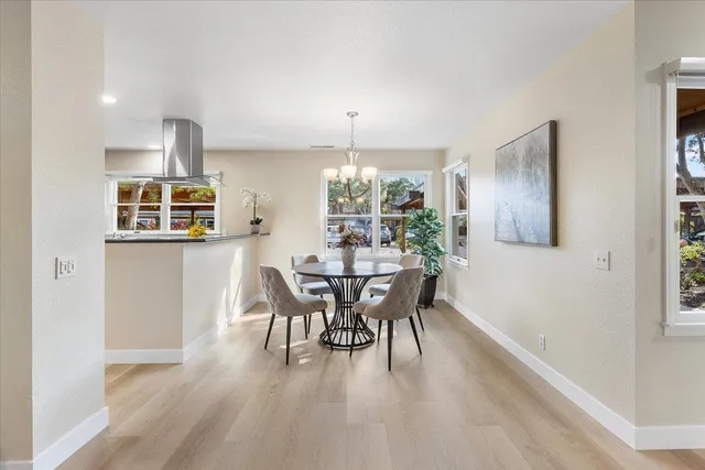 a dining room with furniture a livingroom and chandelier
