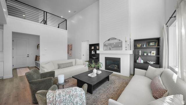 324 North Rhyolite Drive, Unit 87 Hurricane, UT 84737 - Photo 10 of 33 Living area featuring a high ceiling, wood finished floors, a large fireplace, and recessed lighting