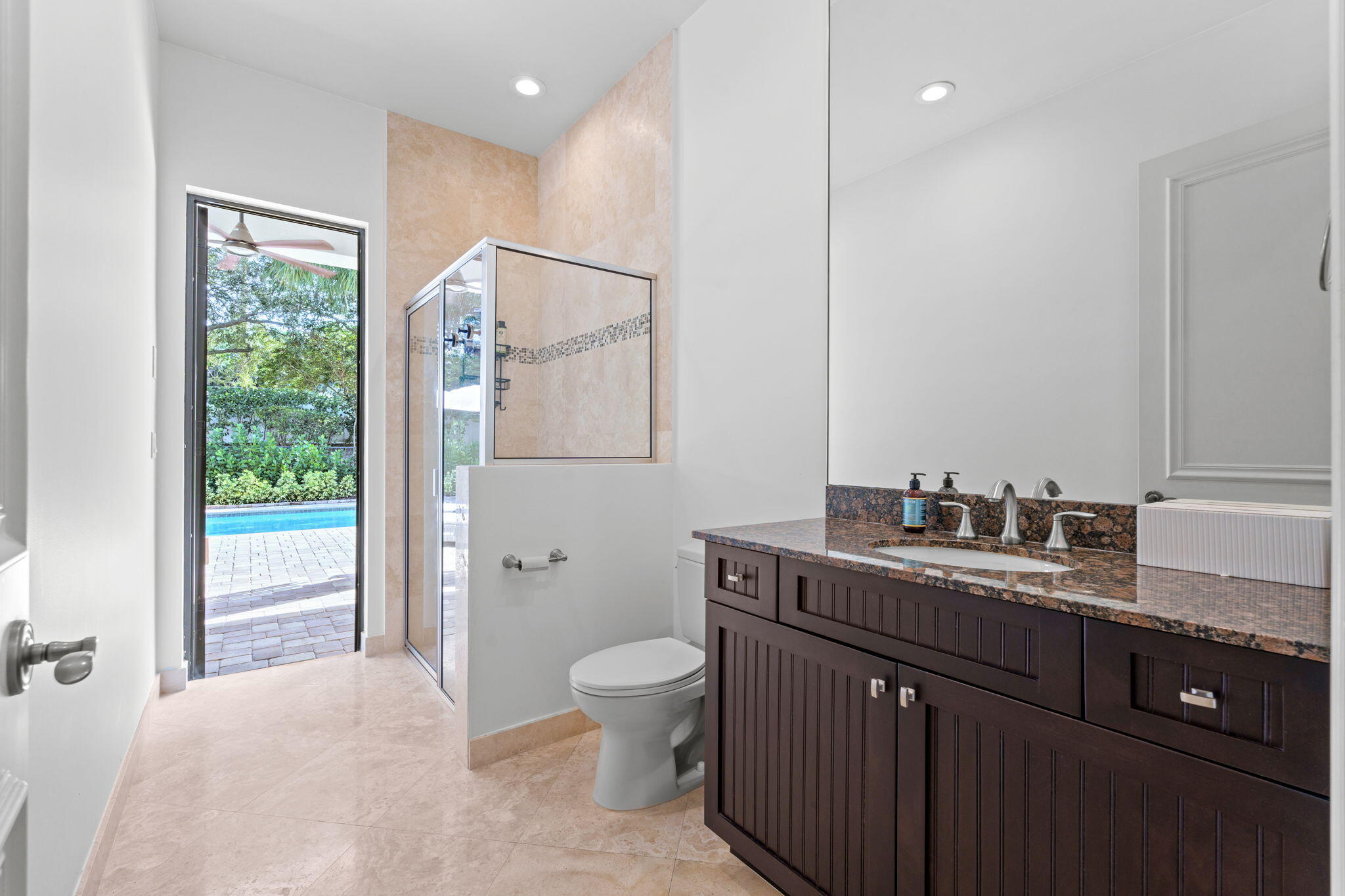 17814 Cadena Drive Boca Raton, FL 33496 - Photo 12 of 46 a bathroom with a granite countertop sink a toilet a mirror and shower