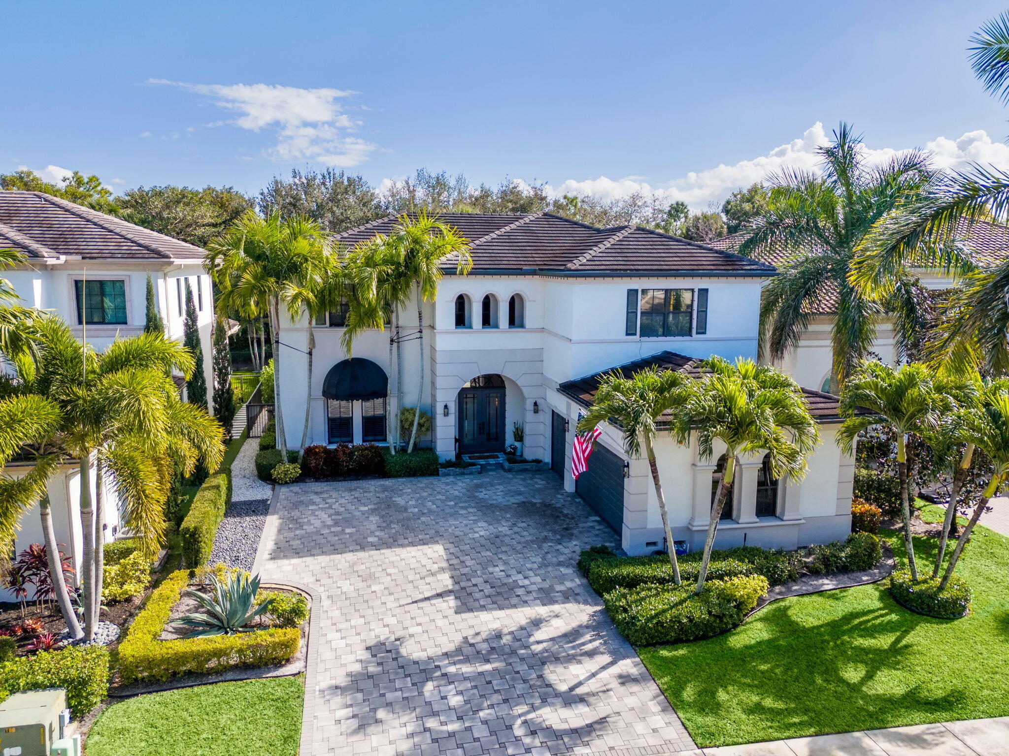 17814 Cadena Drive Boca Raton, FL 33496 - Photo 35 of 46 a front view of a house with a garden