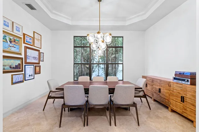 a living room with furniture kitchen view and a large window