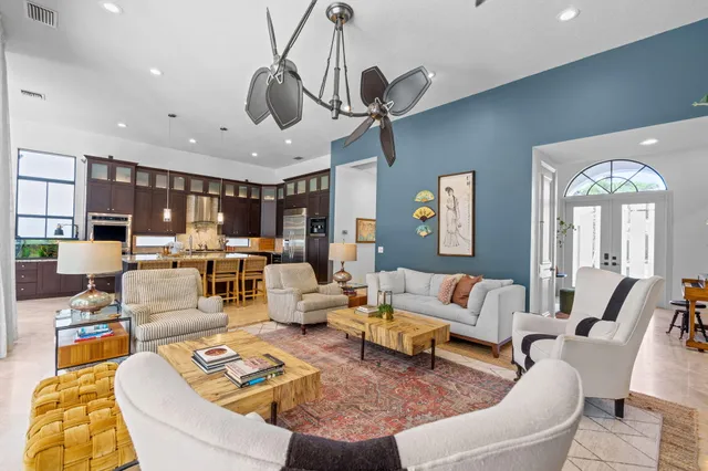 a kitchen with stainless steel appliances kitchen island granite countertop a refrigerator and a stove top oven