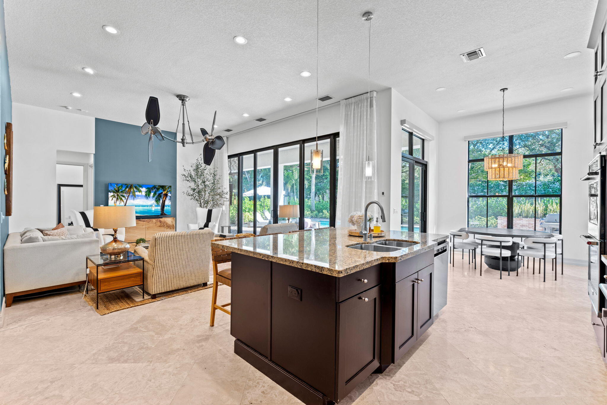 17814 Cadena Drive Boca Raton, FL 33496 - Photo 10 of 46 a kitchen with stainless steel appliances granite countertop a stove and a view of living room