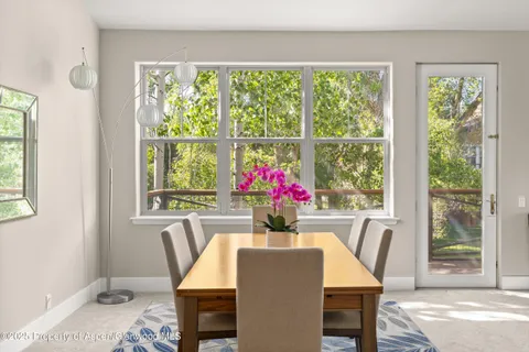 a view of a dining room with furniture window and outside view