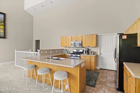a kitchen with a dining table and chairs