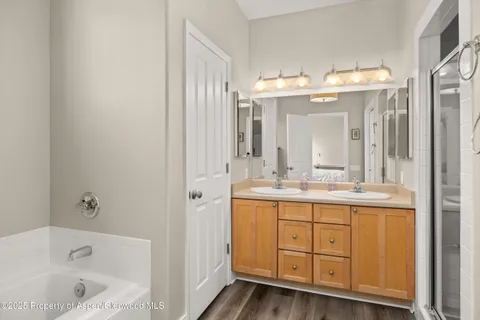 a bathroom with a double vanity sink and a bathtub