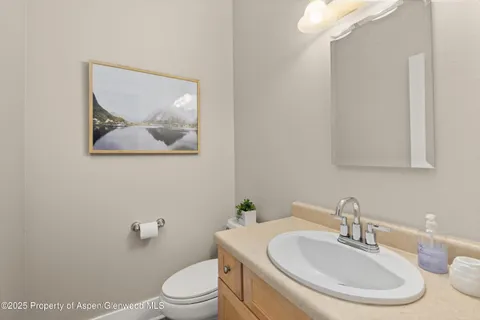 a bathroom with a toilet a sink and a mirror