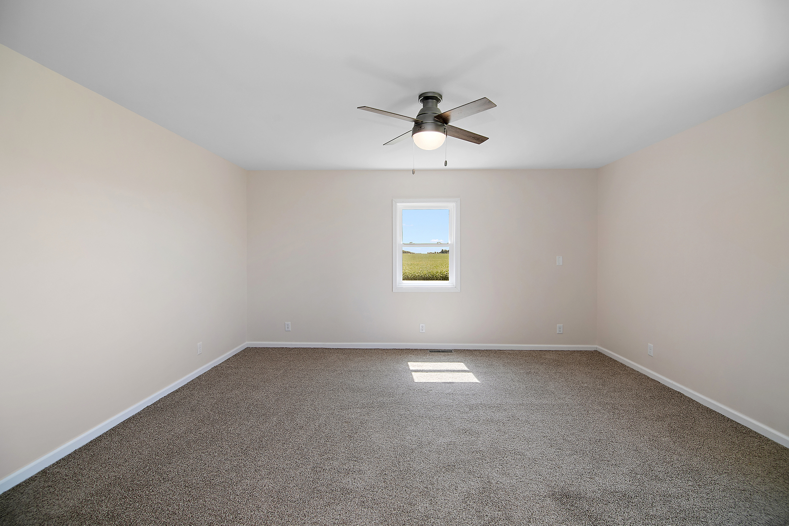 2695 North 1000 East Road Ashkum, IL 60911 - Photo 12 of 31 an empty room with a window and a fan