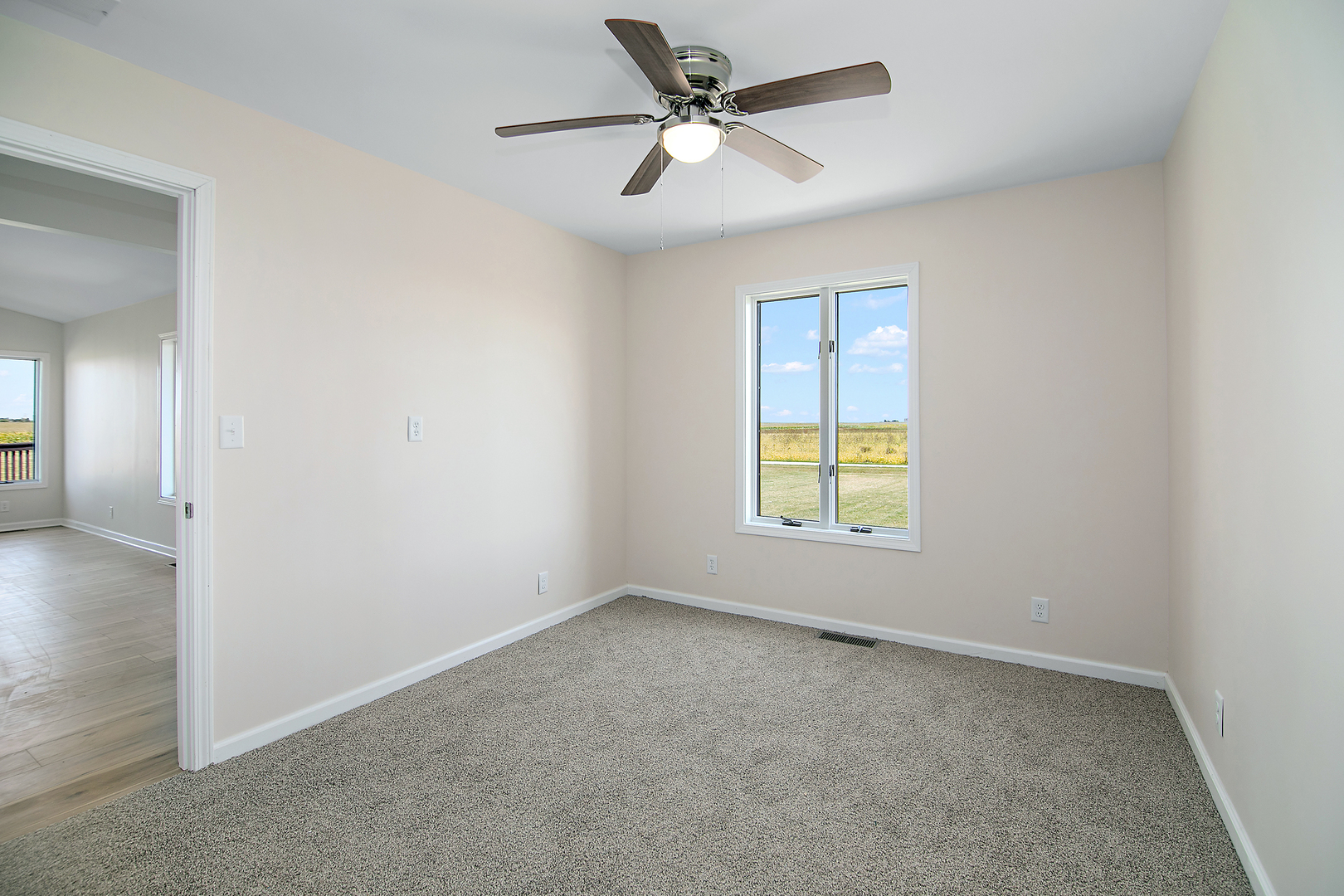 2695 North 1000 East Road Ashkum, IL 60911 - Photo 20 of 31 an empty room with windows and fan