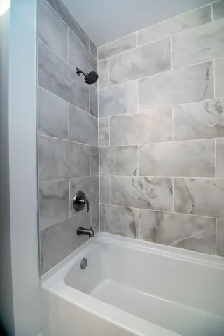 a bathroom with a bathtub and a shower