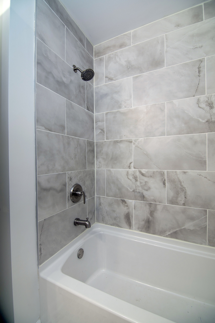 2695 North 1000 East Road Ashkum, IL 60911 - Photo 24 of 31 a bathroom with a bathtub and a shower