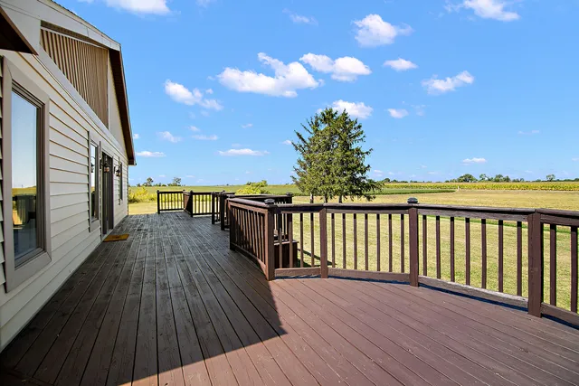 a view of balcony with wooden floor and seating space