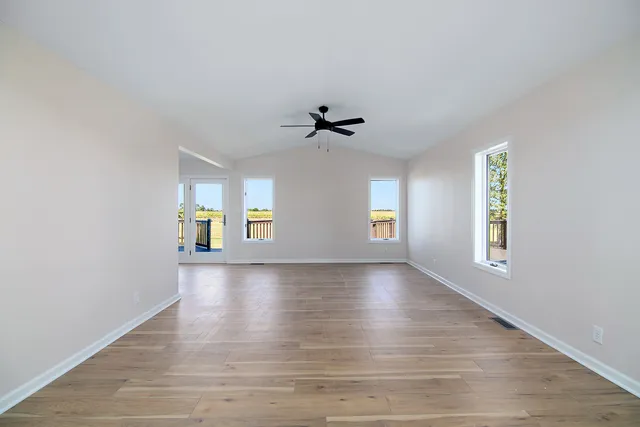 wooden floor in an empty room with a window