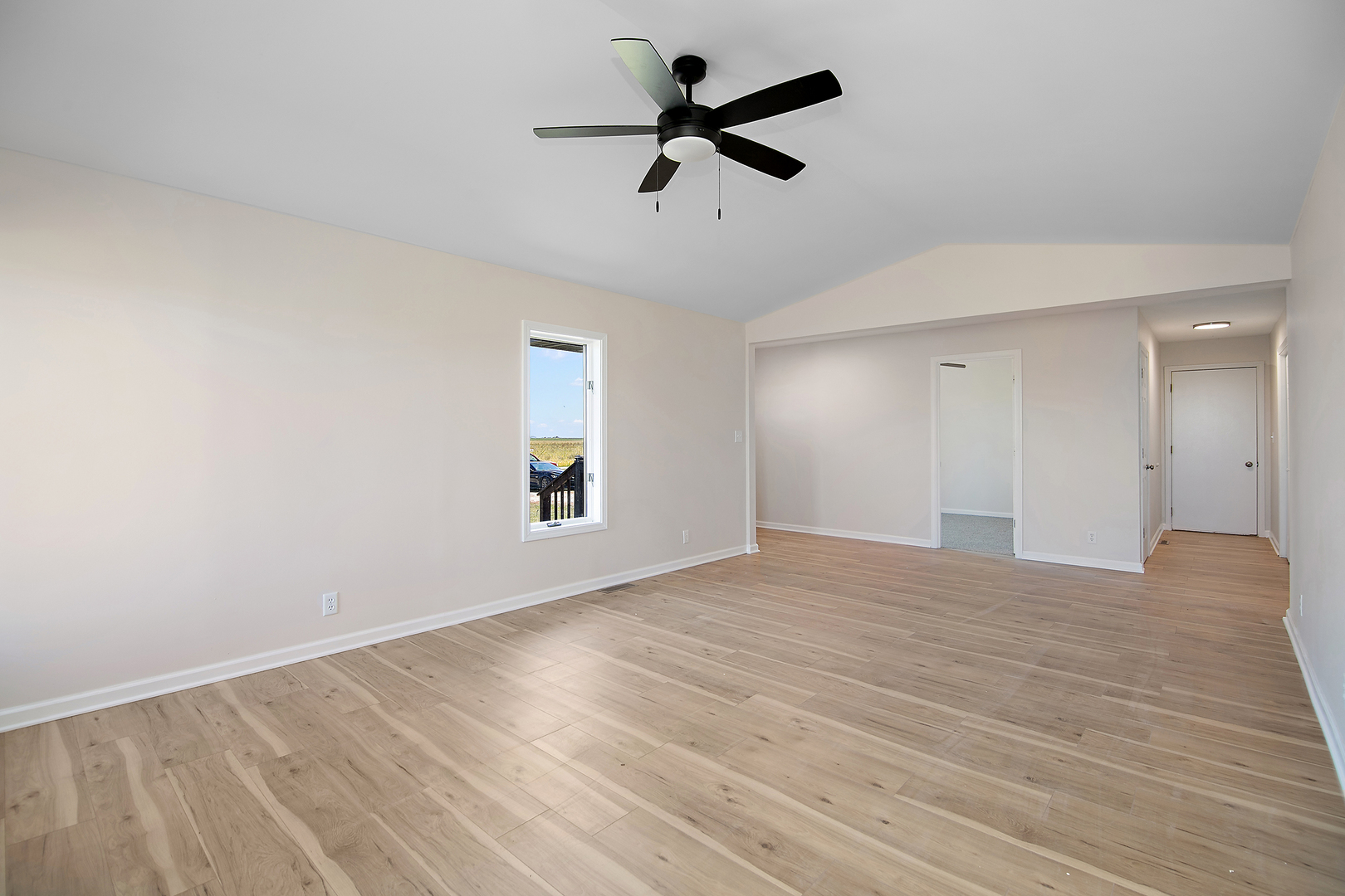 2695 North 1000 East Road Ashkum, IL 60911 - Photo 6 of 31 a view of empty room with wooden floor and ceiling fan