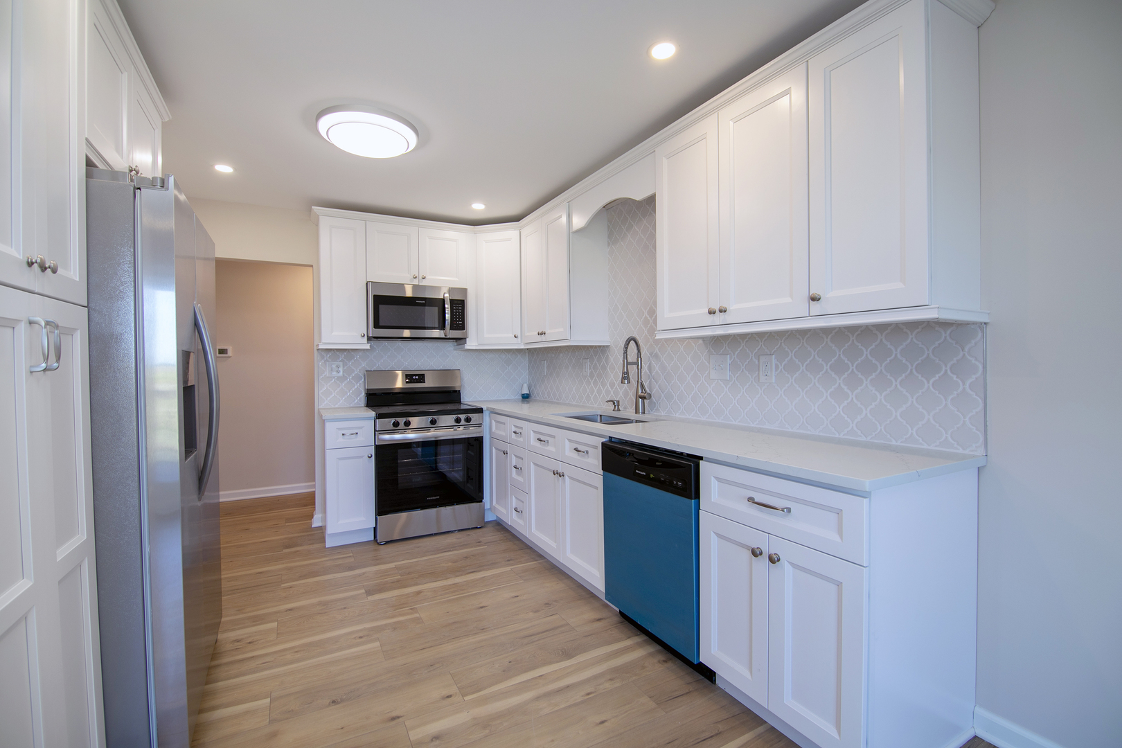2695 North 1000 East Road Ashkum, IL 60911 - Photo 9 of 31 a kitchen with granite countertop white cabinets and stainless steel appliances