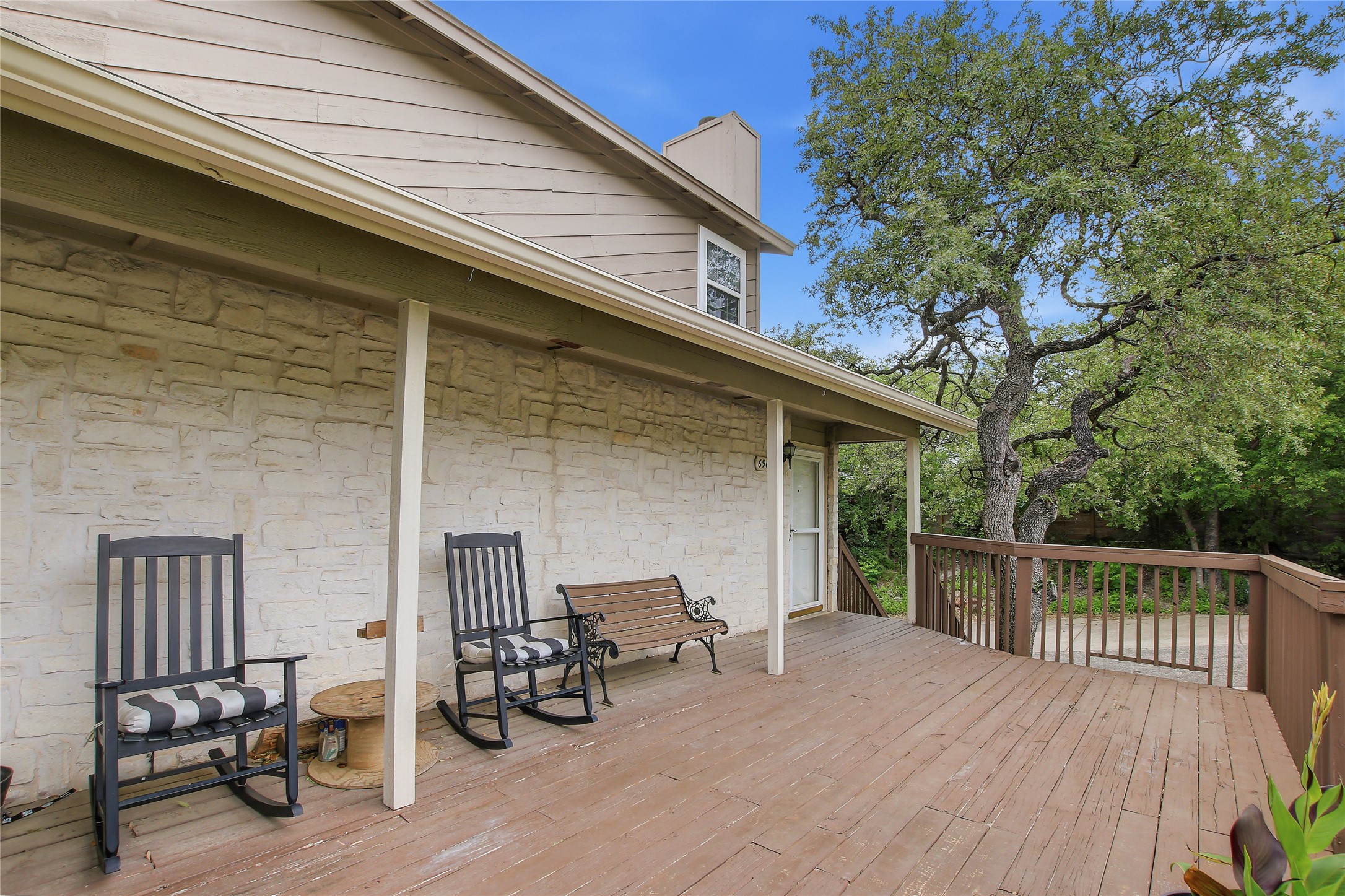 6902 Rifle Bend, Unit B Austin, TX 78736 - Photo 33 of 34 a view of a deck with table and chairs and wooden floor