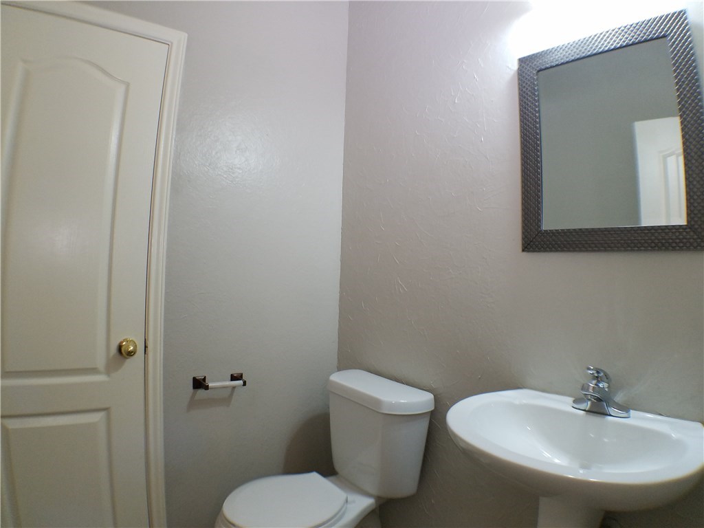 2208 Hayfield Square Pflugerville, TX 78660 - Photo 11 of 29 a bathroom with a toilet a sink and mirror