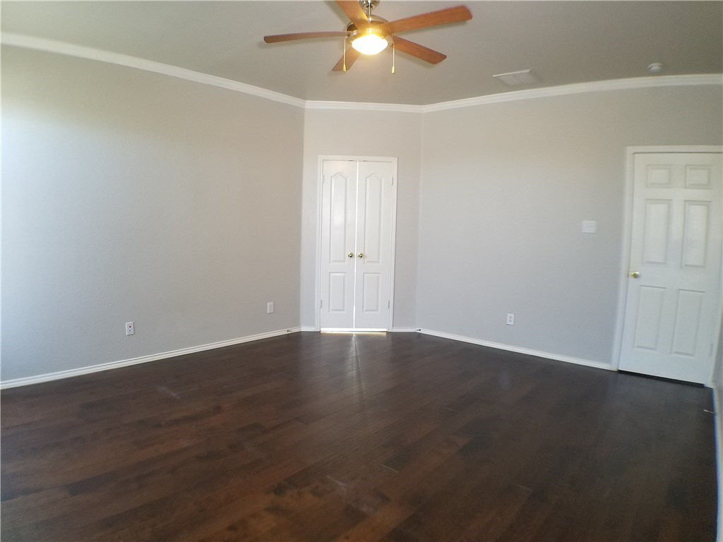 2208 Hayfield Square Pflugerville, TX 78660 - Photo 16 of 29 an empty room with wooden floor fan and windows