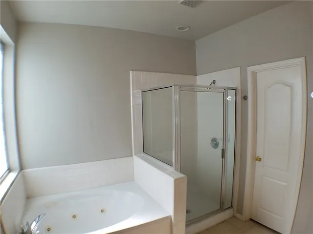 a bathroom with a bathtub and a shower