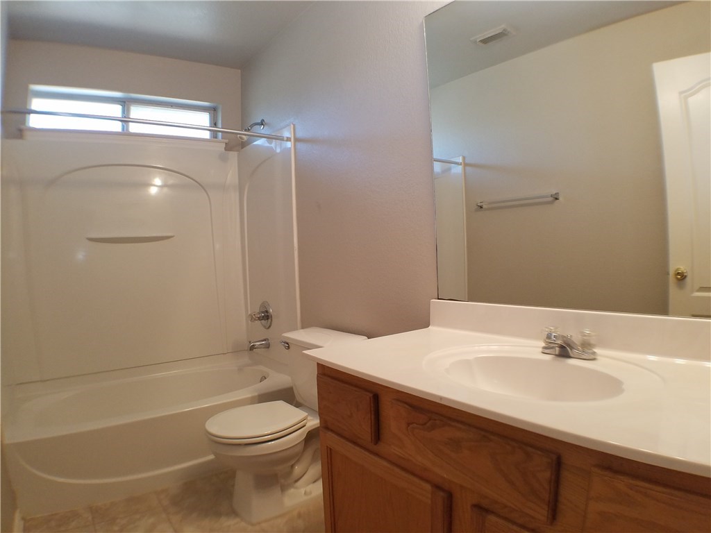 2208 Hayfield Square Pflugerville, TX 78660 - Photo 27 of 29 a bathroom with a sink toilet and shower