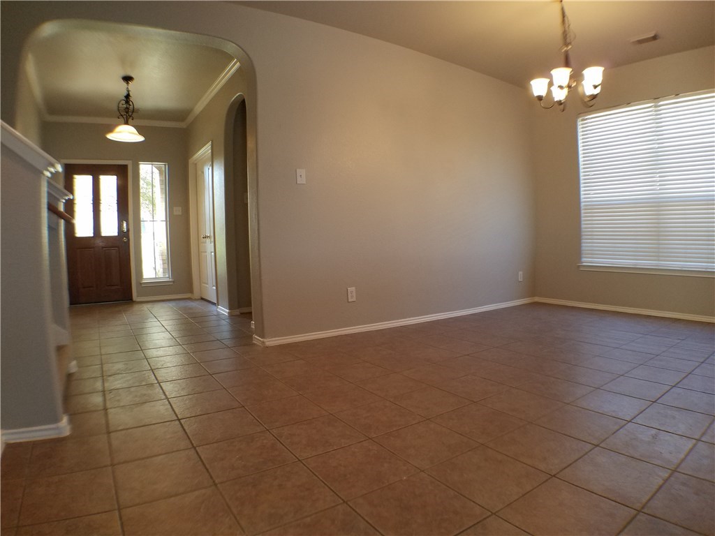2208 Hayfield Square Pflugerville, TX 78660 - Photo 6 of 29 an empty room with a bathroom and a chandelier fan