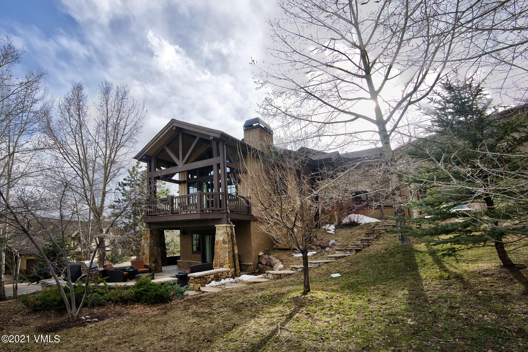 5691 Wildridge Road East Avon, CO 81620 - Photo 5 of 45 Side deck and patio surrounded by trees