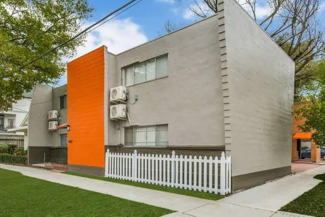 a backyard of a house with a small garden and deck