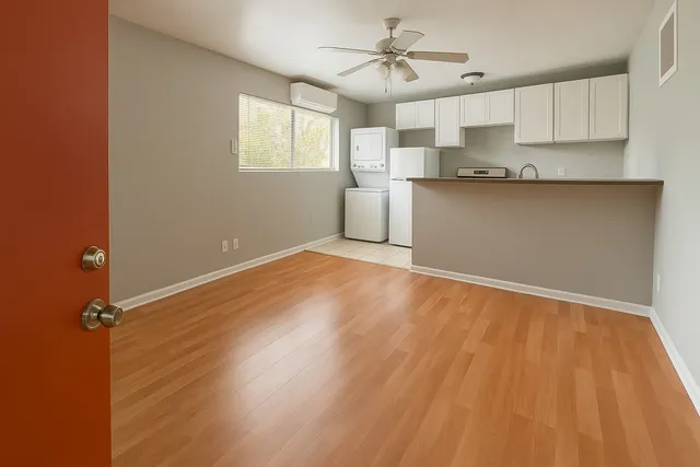 a view of a kitchen with a sink cabinets and wooden floor
