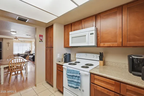 a kitchen with a stove a sink and cabinets