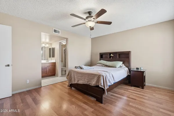 a bedroom with a bed and a ceiling fan