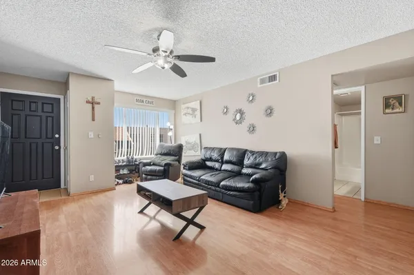 a living room with furniture and wooden floor