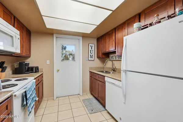 a kitchen with stainless steel appliances granite countertop a refrigerator a stove a sink and a refrigerator