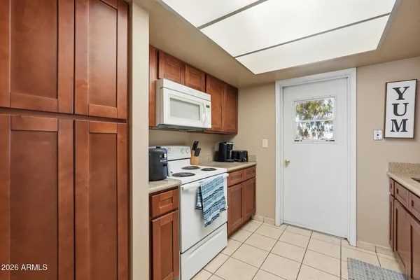 a view of a kitchen with electric appliances
