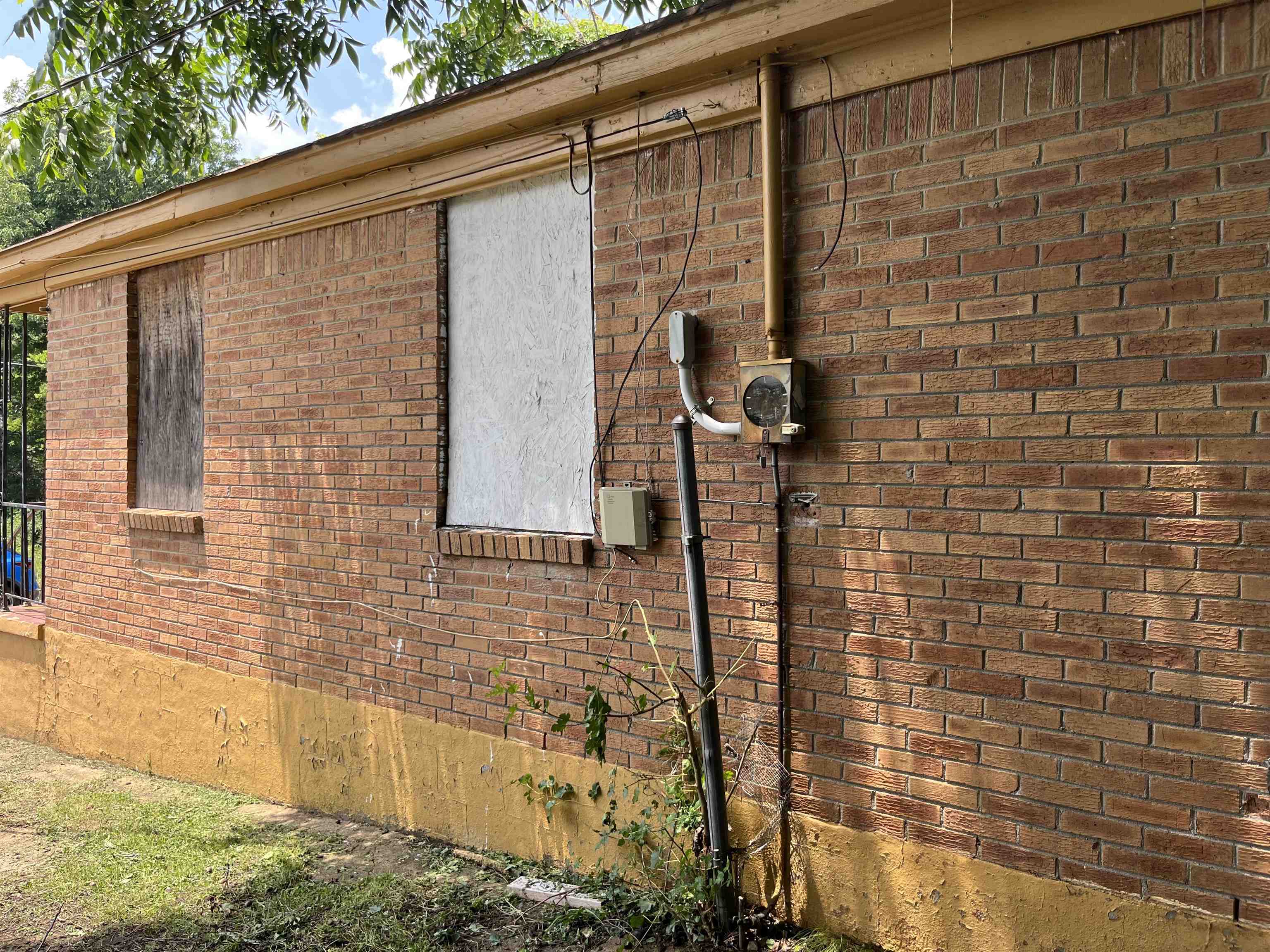 100 Silverage Avenue Memphis, TN 38109 - Photo 4 of 30 Brick exterior with board-covered windows and an exposed electrical meter
