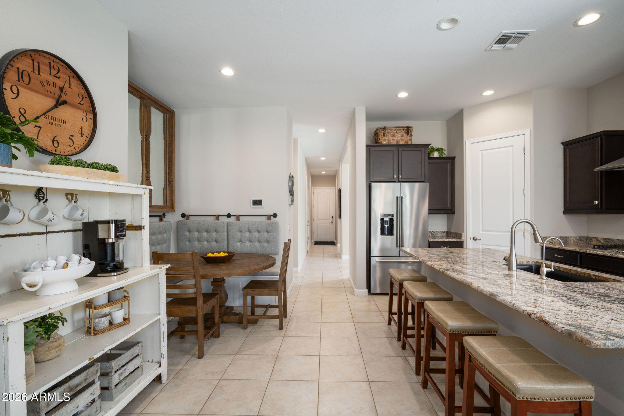 18236 North 66th Way Phoenix, AZ 85054 - Photo 15 of 17 a kitchen with stainless steel appliances kitchen island granite countertop a refrigerator and a stove top oven