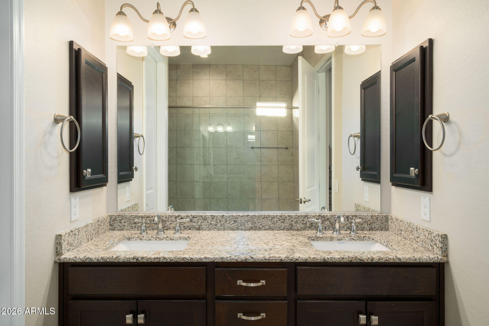 18236 North 66th Way Phoenix, AZ 85054 - Photo 8 of 17 a bathroom with a granite countertop sink and a mirror