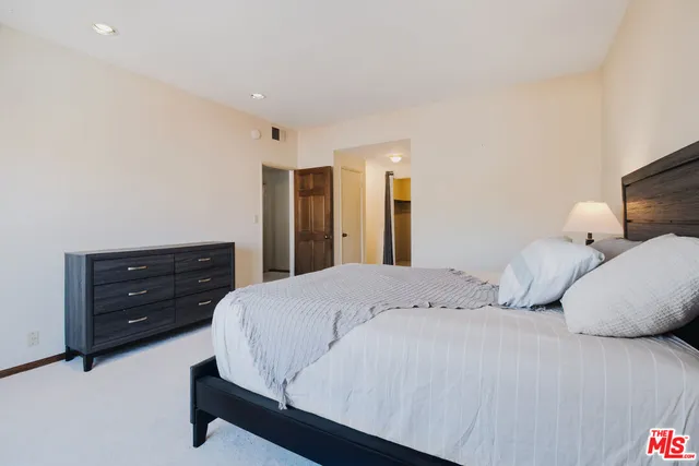 a bedroom with a bed and a dresser